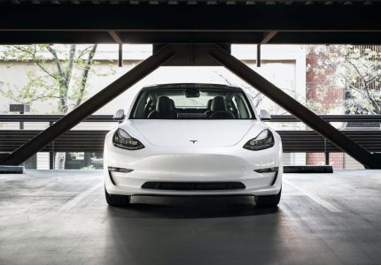 White Tesla car parked.