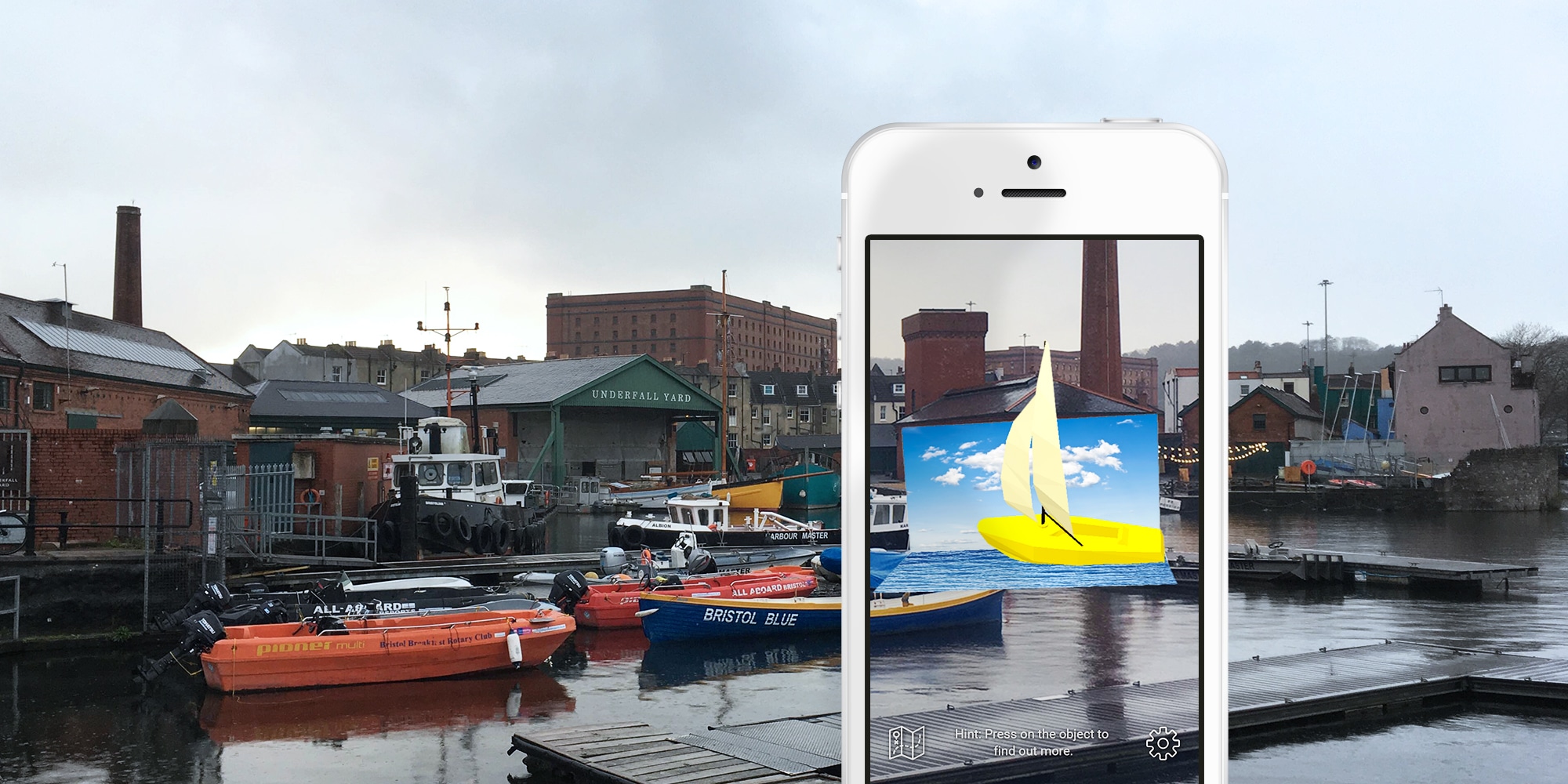 Underfall Boatyard with mobile phone in the foreground augmenting a 3D cartoon ship.